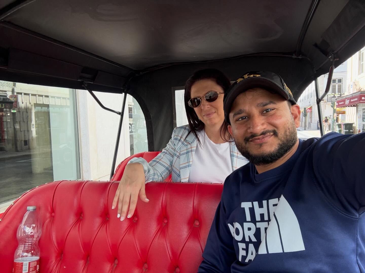 Happy customers with tour guide on a tuk tuk tour in Lisbon