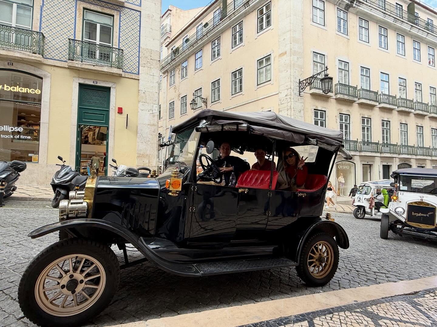 Happy customers with tour guide on a tuk tuk tour in Lisbon