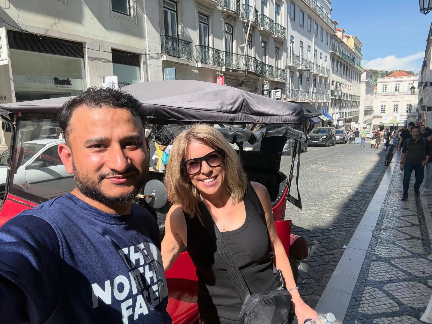 Happy customers with tour guide on a tuk tuk tour in Lisbon
