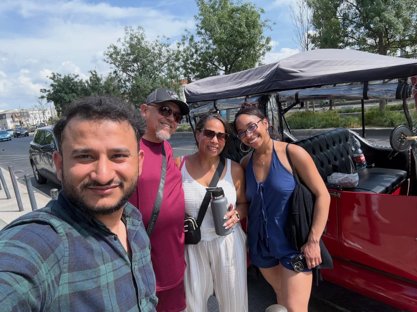 Happy customers with tour guide on a tuk tuk tour in Lisbon