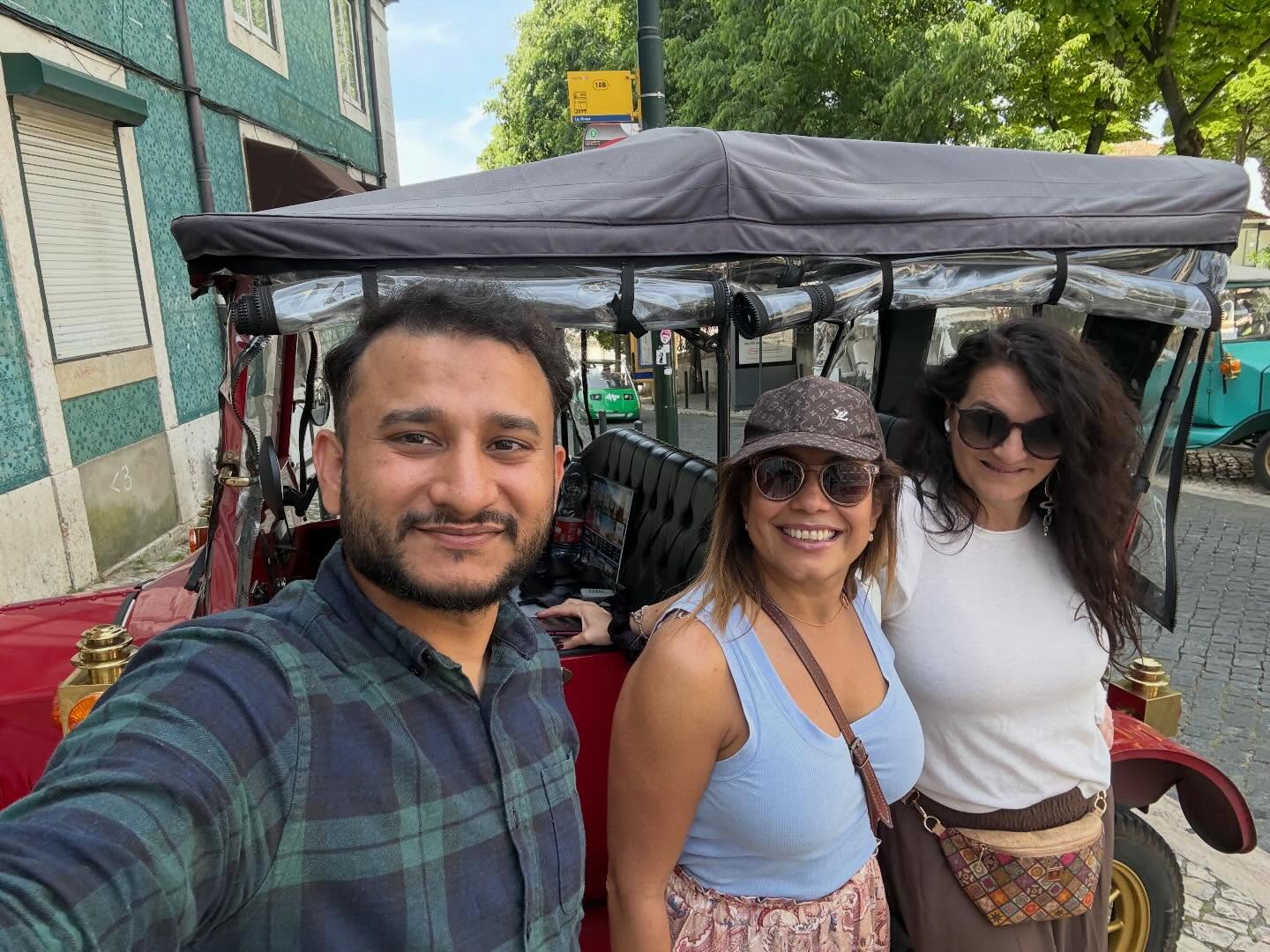 Happy customers with tour guide on a tuk tuk tour in Lisbon