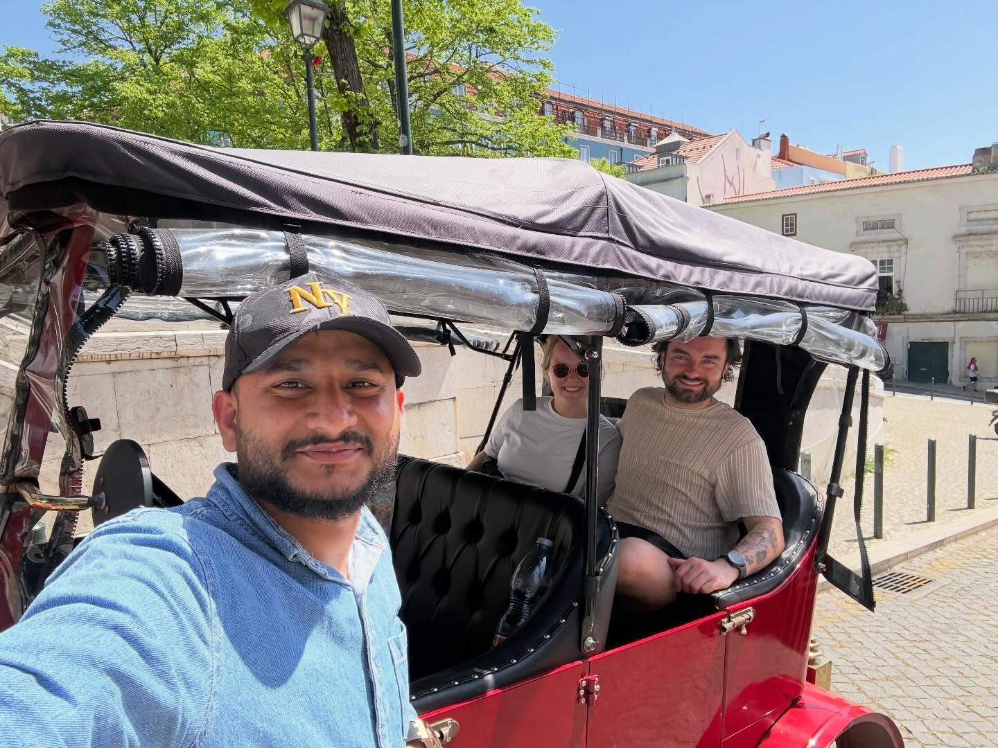 Happy customers with tour guide on a tuk tuk tour in Lisbon