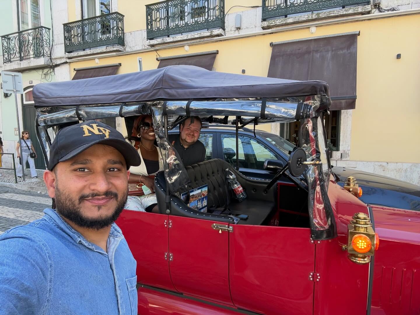 Happy customers with tour guide on a tuk tuk tour in Lisbon