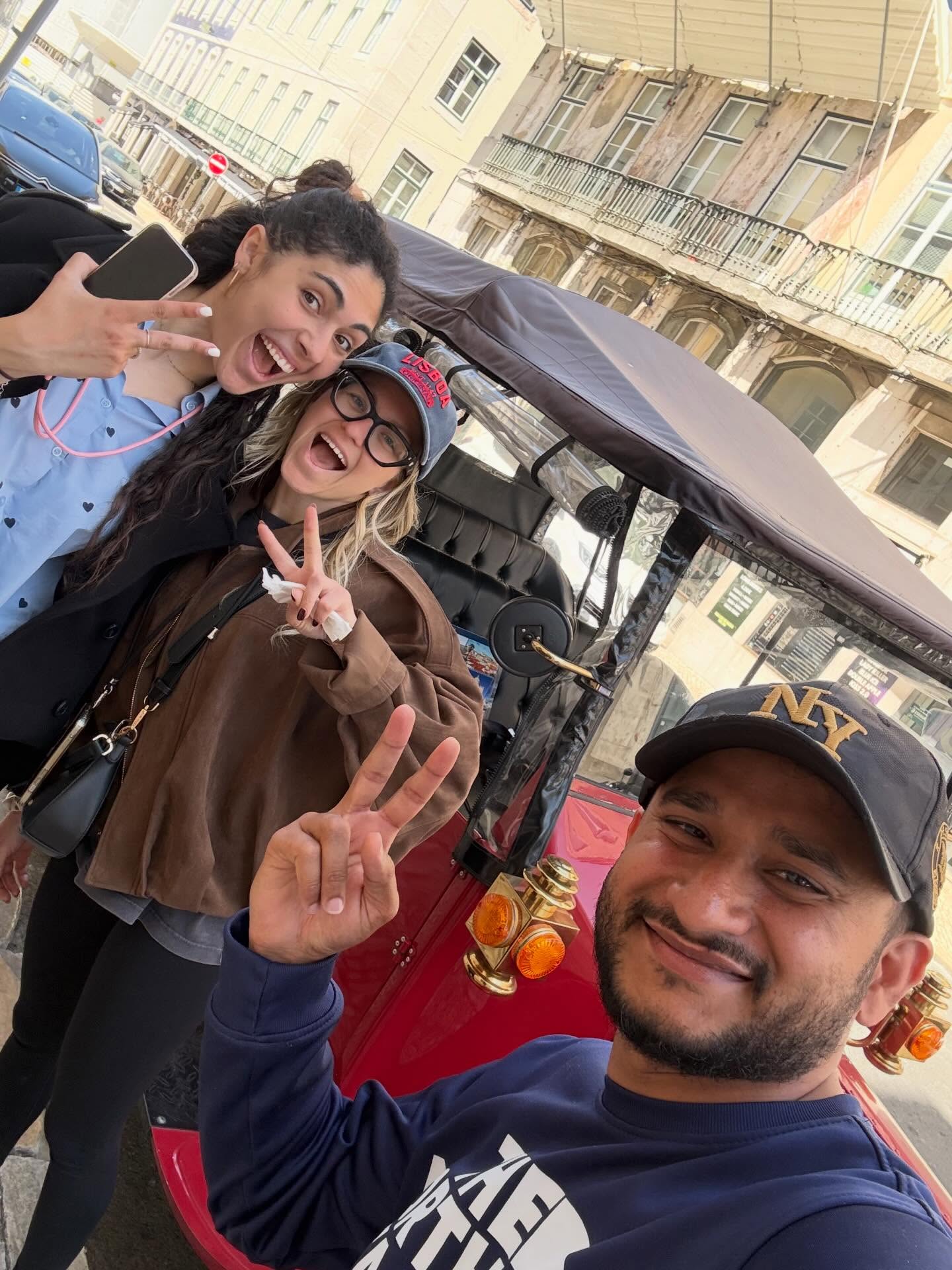Happy customers with tour guide on a tuk tuk tour in Lisbon