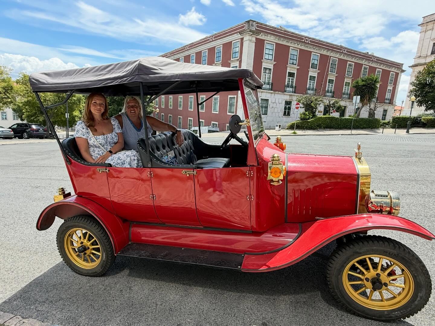 Happy customers with tour guide on a tuk tuk tour in Lisbon