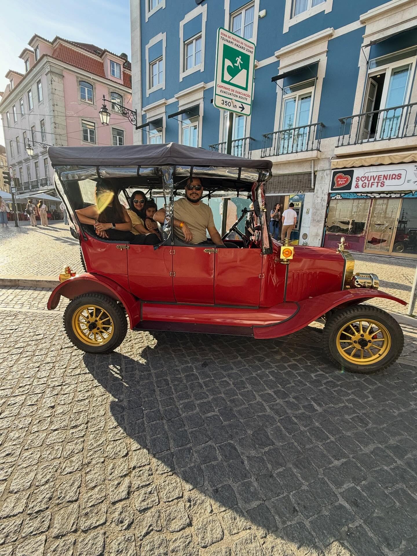 Happy customers with tour guide on a tuk tuk tour in Lisbon