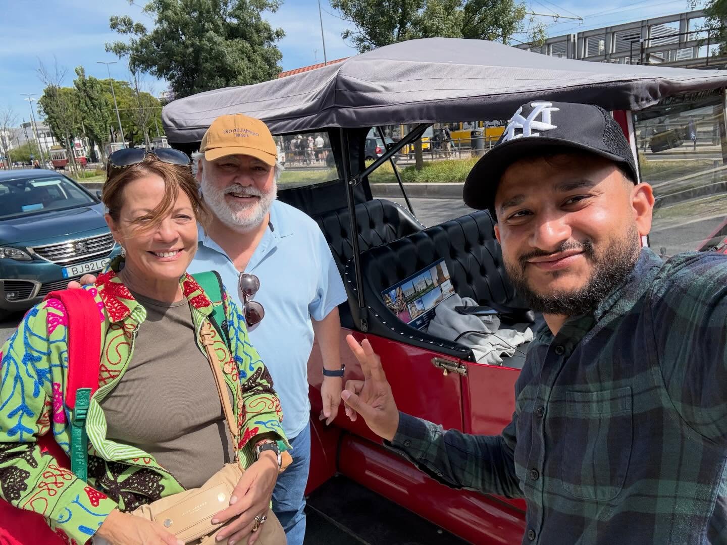 Happy customers with tour guide on a tuk tuk tour in Lisbon