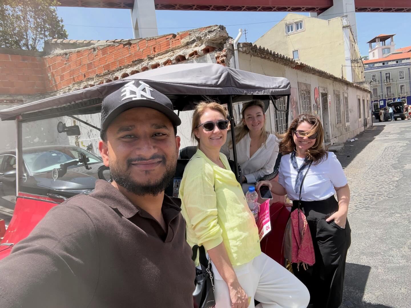 Happy customers with tour guide on a tuk tuk tour in Lisbon